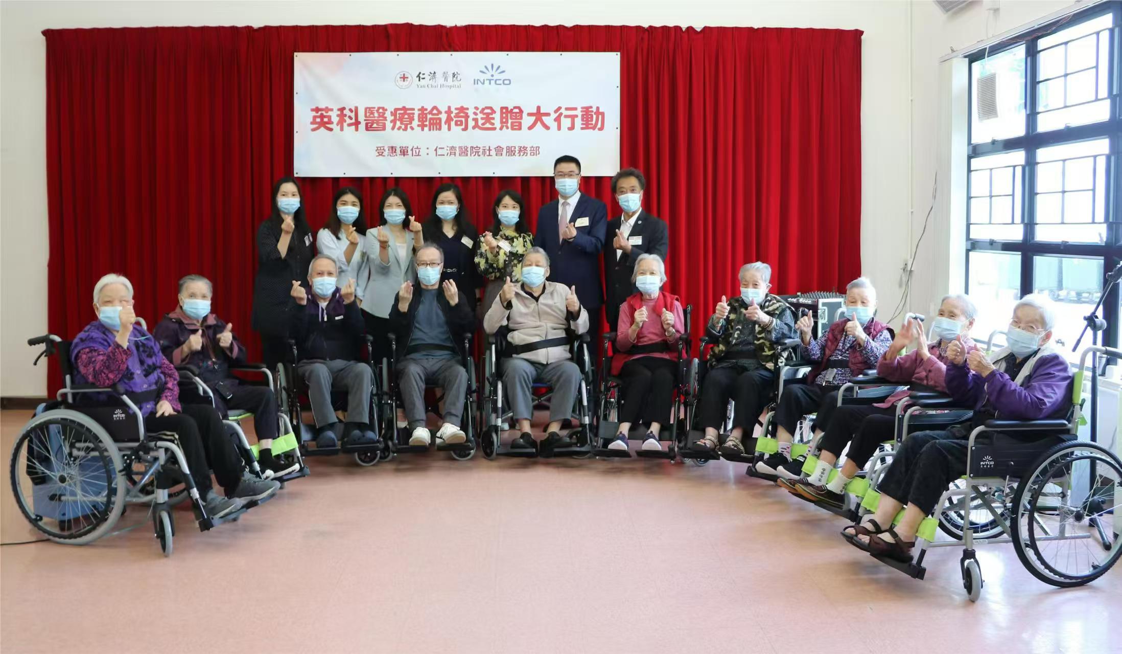 The old man sits in a wheelchair donated by INTCO